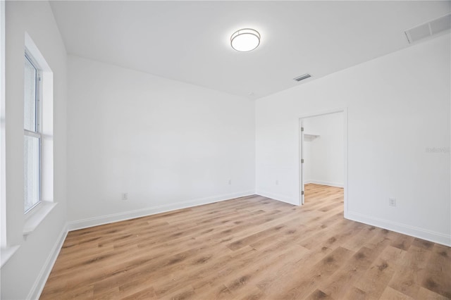 empty room with light hardwood / wood-style flooring