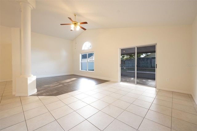 empty room featuring light tile patterned floors, decorative columns, high vaulted ceiling, and ceiling fan