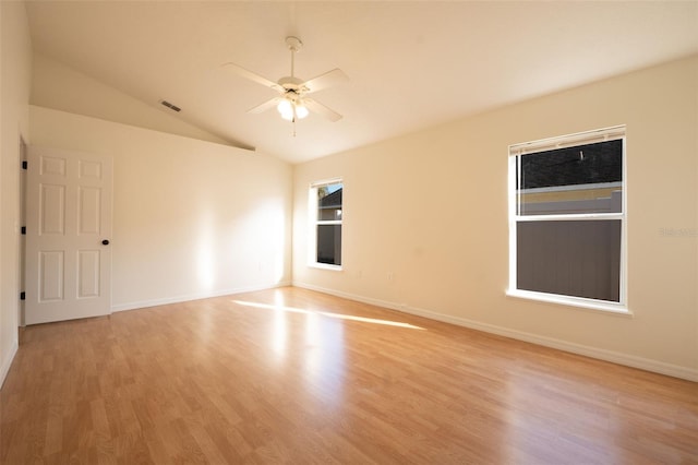 empty room with vaulted ceiling, light hardwood / wood-style flooring, and ceiling fan