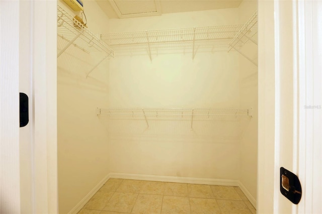 spacious closet featuring tile patterned flooring