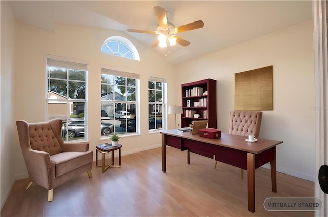 office space featuring light hardwood / wood-style floors, vaulted ceiling, and ceiling fan