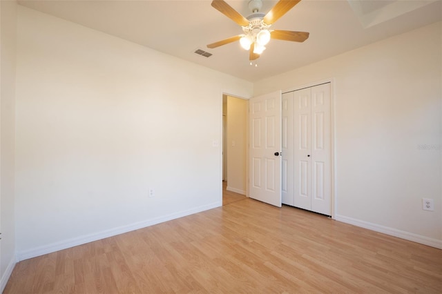 unfurnished bedroom featuring ceiling fan, a closet, and light hardwood / wood-style flooring