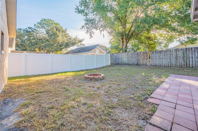 view of yard with an outdoor fire pit