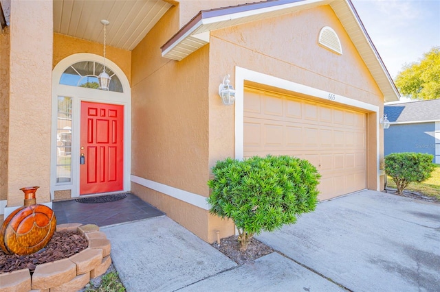 view of exterior entry with a garage