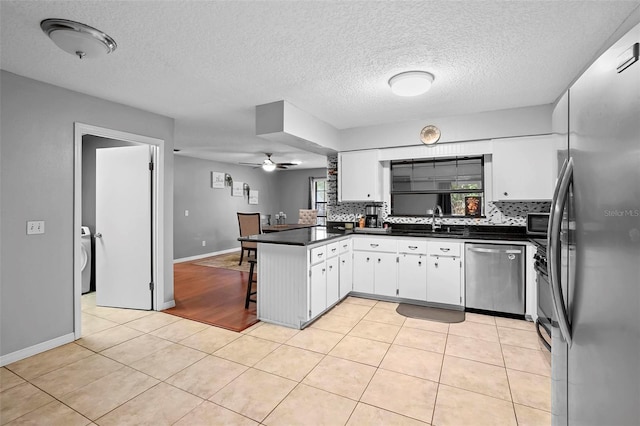 1195 Glen Royal Ter, Deland, FL 32720 - kitchen featuring stainless steel appliances, a sink, dark countertops, a peninsula, and ceiling fan