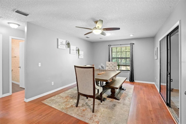 1195 Glen Royal Ter, Deland, FL 32720 - dining space featuring wood finished floors, a ceiling fan, a textured ceiling, and baseboards