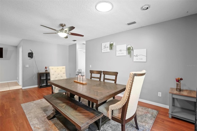 1195 Glen Royal Ter, Deland, FL 32720 - dining area featuring light wood-type flooring, a ceiling fan, baseboards, and a textured ceiling