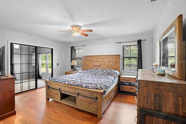 1195 Glen Royal Ter, Deland, FL 32720 - bedroom with wood finished floors, access to outside, a textured ceiling, and a ceiling fan