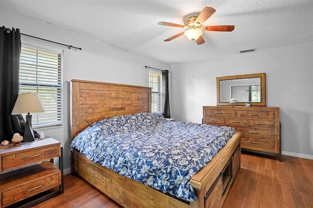 1195 Glen Royal Ter, Deland, FL 32720 - bedroom featuring wood finished floors, a textured ceiling, baseboards, and a ceiling fan