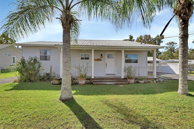 view of front of property with covered porch and a front yard