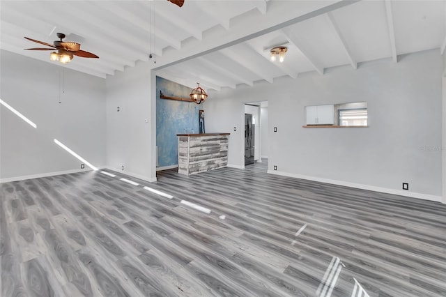 unfurnished living room featuring lofted ceiling with beams, ceiling fan, wood-type flooring, and indoor bar