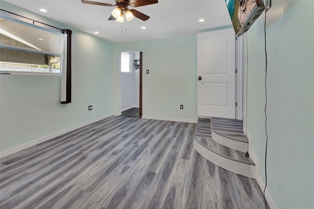 unfurnished room with light hardwood / wood-style floors, a wealth of natural light, and ceiling fan