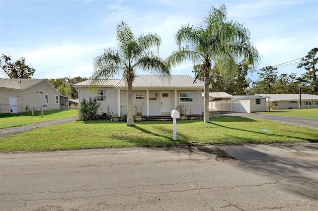 view of front of home with a front lawn and a carport