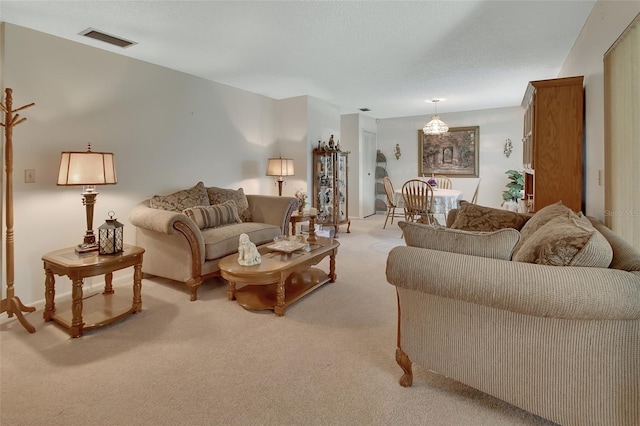 carpeted living room with a textured ceiling