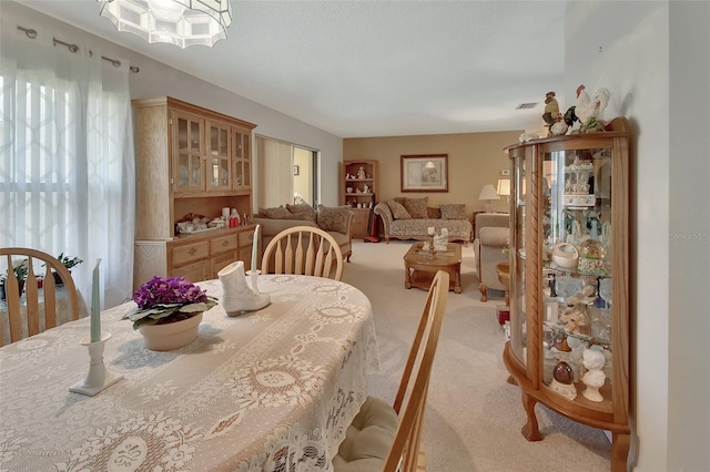 dining area featuring light colored carpet