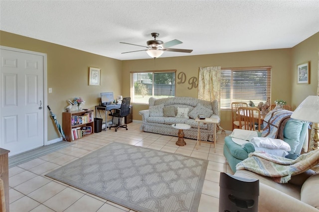 tiled living room with ceiling fan and a textured ceiling