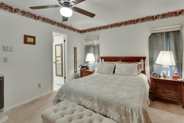 bedroom featuring light carpet, a textured ceiling, and ceiling fan