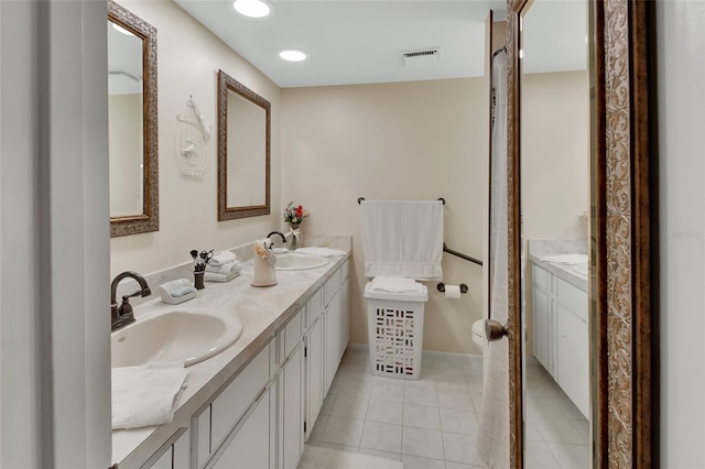 bathroom with tile patterned floors and vanity