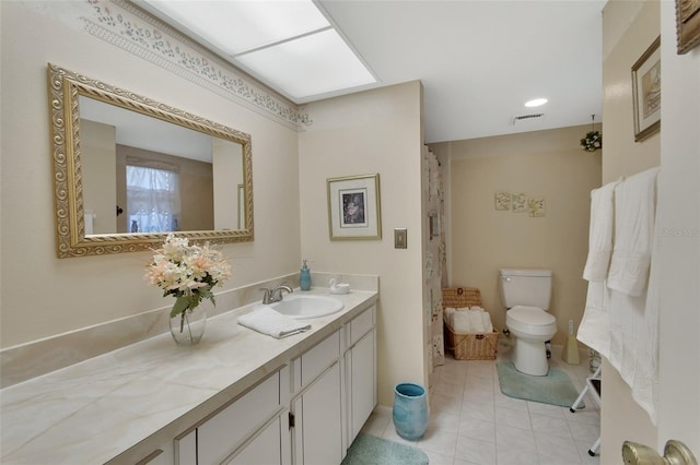 bathroom with tile patterned floors, vanity, and toilet