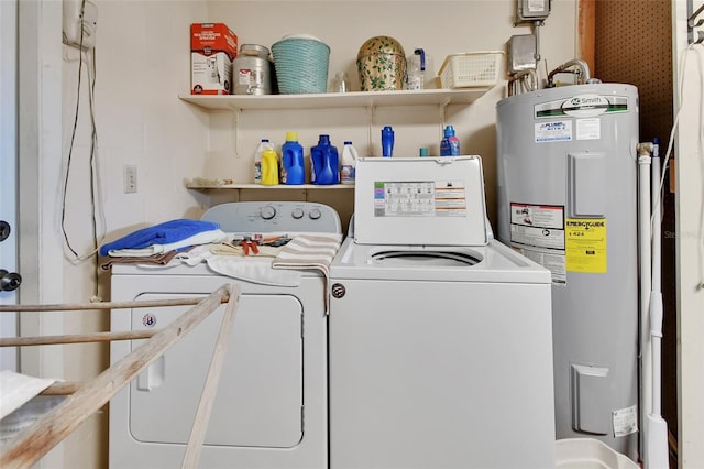 clothes washing area with washing machine and clothes dryer and water heater