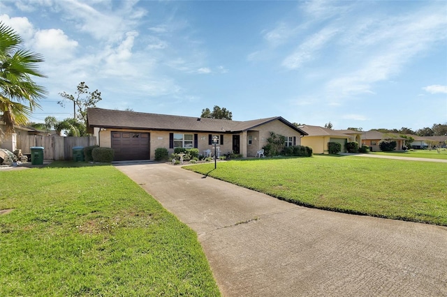 ranch-style home with a garage and a front lawn