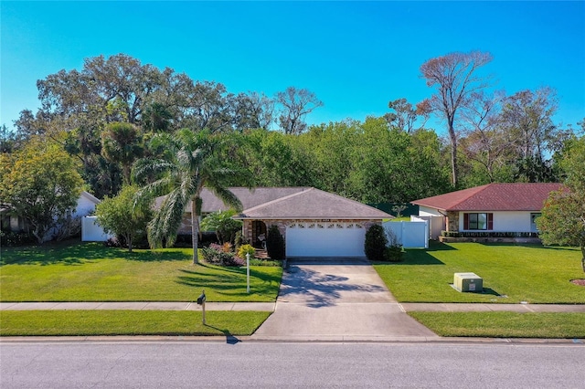 ranch-style home featuring a front lawn and a garage