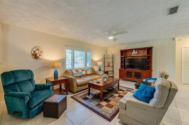 tiled living room with ceiling fan and a textured ceiling