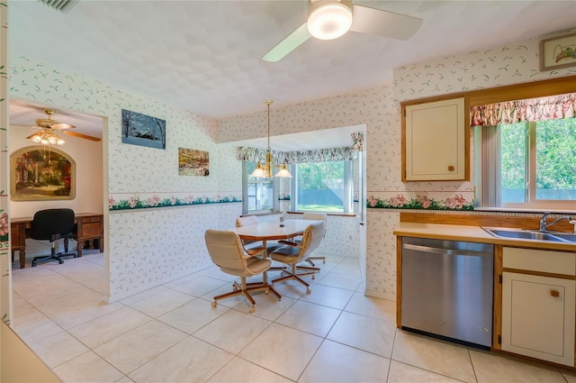 kitchen featuring stainless steel dishwasher, decorative light fixtures, a healthy amount of sunlight, and sink