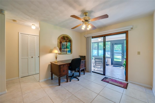 tiled office space featuring ceiling fan