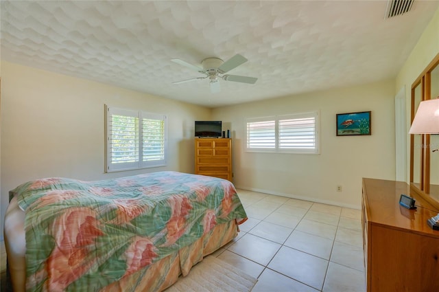 bedroom featuring light tile patterned flooring, multiple windows, and ceiling fan