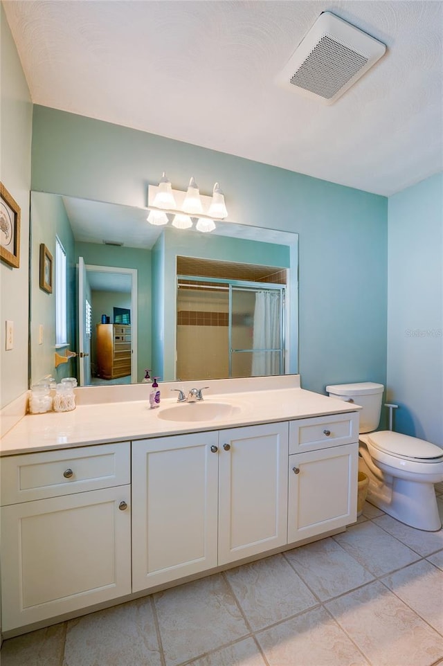 bathroom with walk in shower, tile patterned flooring, vanity, and toilet