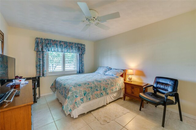 bedroom featuring light tile patterned floors and ceiling fan