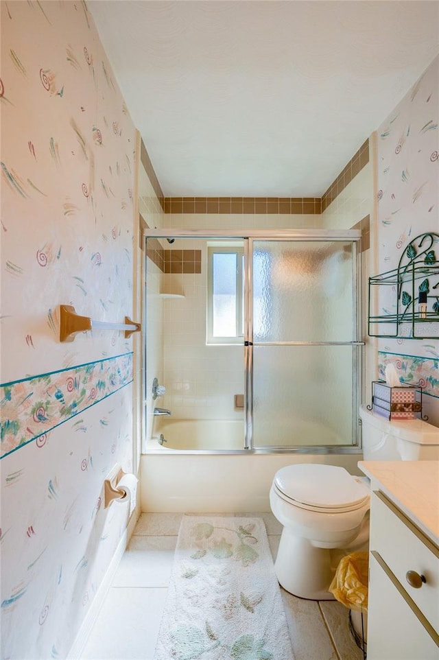 full bathroom with tile patterned flooring, vanity, toilet, and combined bath / shower with glass door