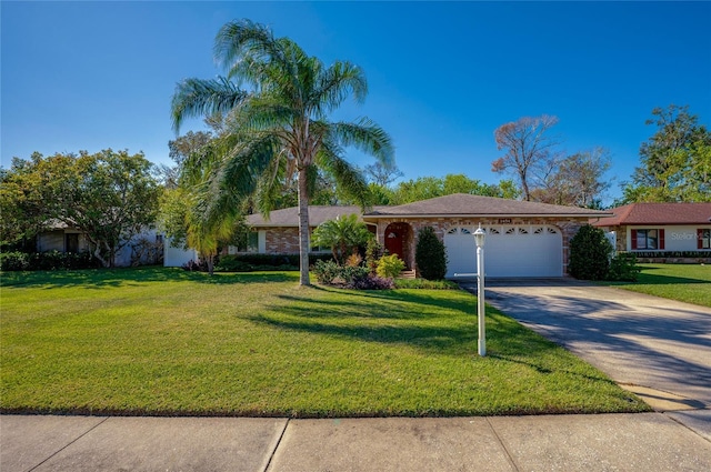 ranch-style house featuring a garage and a front lawn