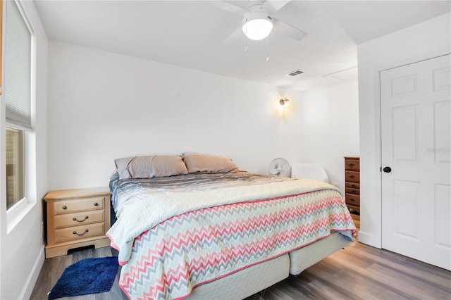 bedroom with dark hardwood / wood-style floors and ceiling fan