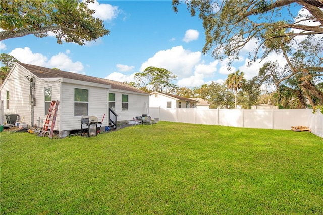 rear view of property featuring a lawn