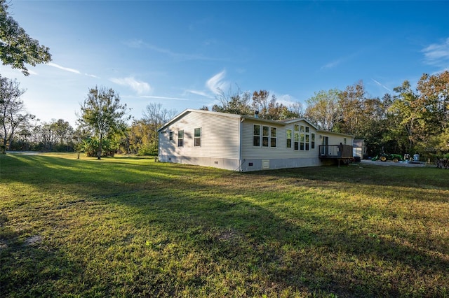 view of side of property with a wooden deck and a yard