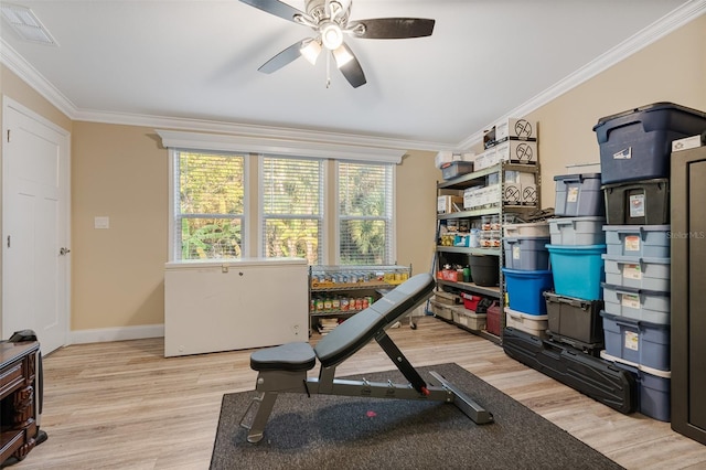 workout area with crown molding, wood finished floors, baseboards, visible vents, and ceiling fan
