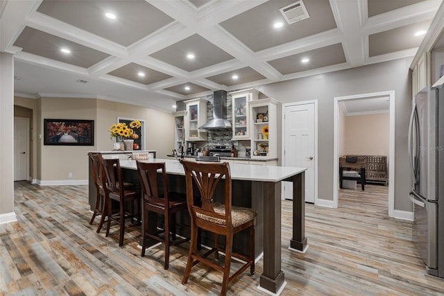 bar featuring visible vents, stainless steel appliances, tasteful backsplash, wall chimney range hood, and coffered ceiling