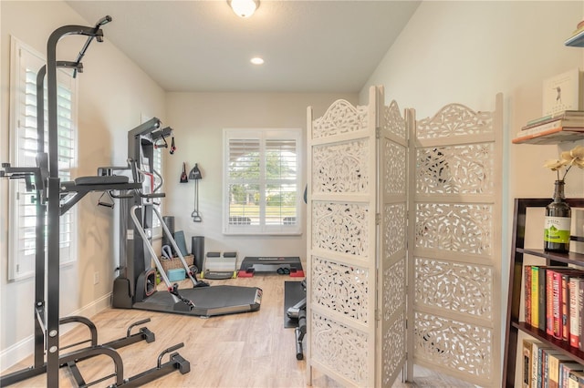 workout area with hardwood / wood-style floors