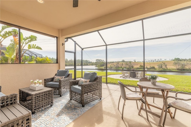 sunroom / solarium with a water view