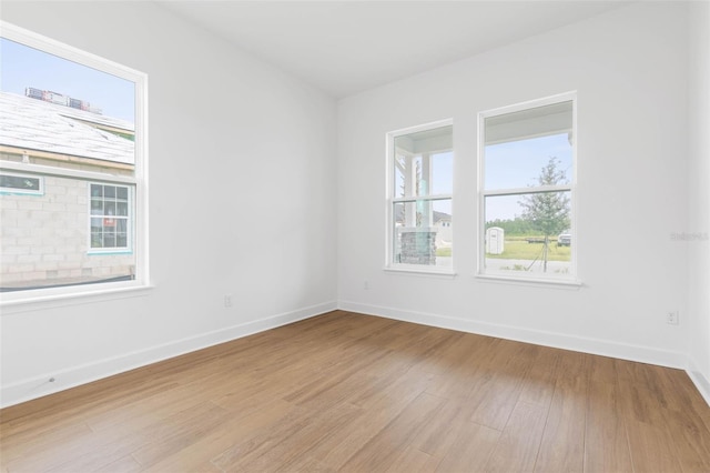 spare room with hardwood / wood-style floors