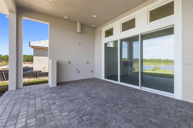 view of patio with a water view