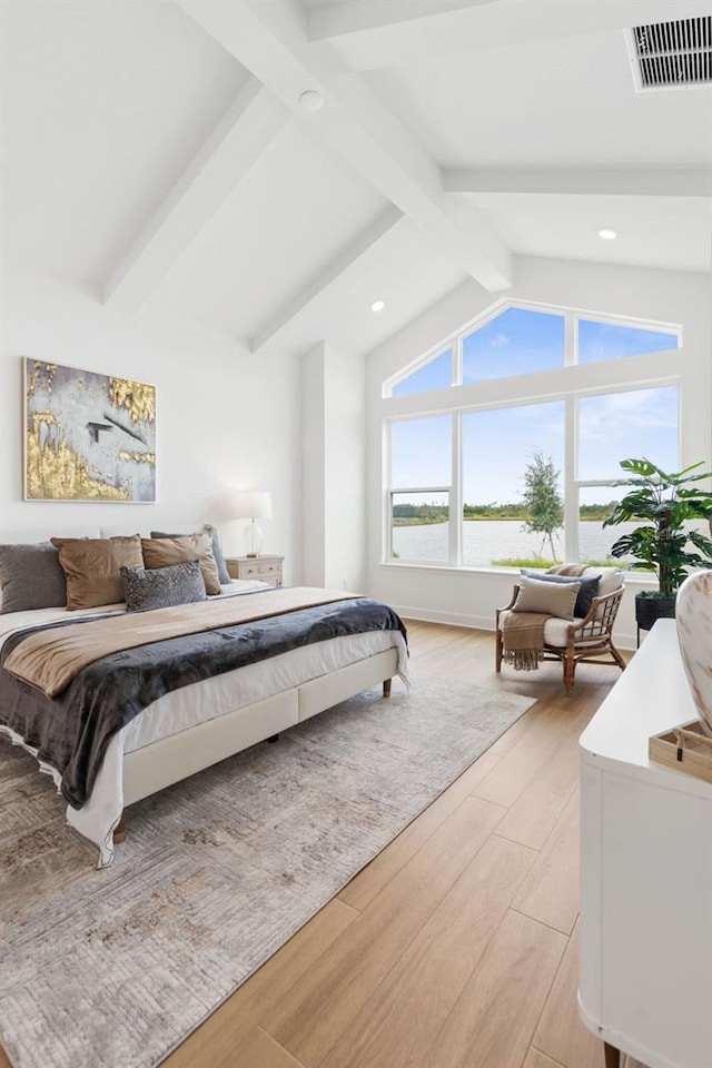 bedroom with light hardwood / wood-style flooring and lofted ceiling with beams