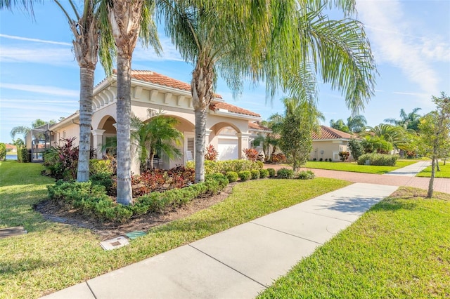 mediterranean / spanish-style home with a front yard