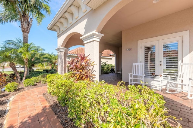 view of exterior entry featuring french doors