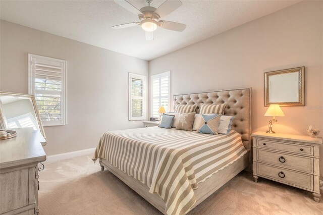 bedroom with ceiling fan and light carpet