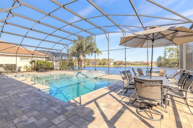 view of swimming pool with glass enclosure, a water view, and a patio