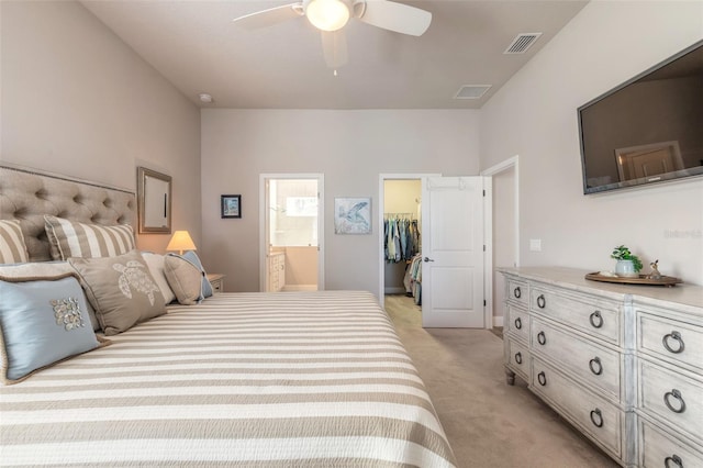 carpeted bedroom featuring ceiling fan, a walk in closet, connected bathroom, and a closet