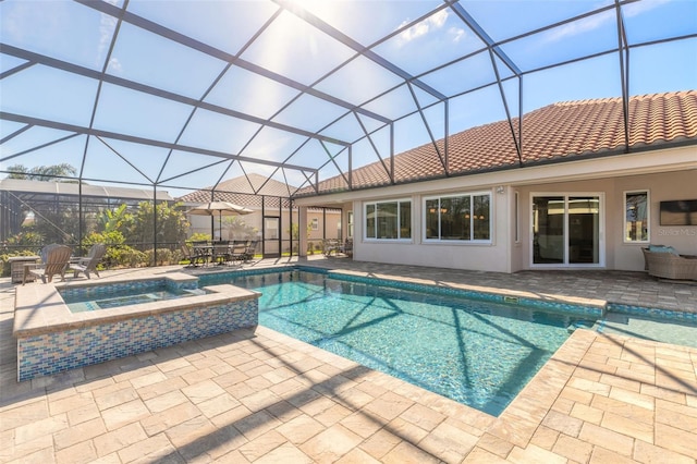 view of pool with a patio area, a lanai, and an in ground hot tub